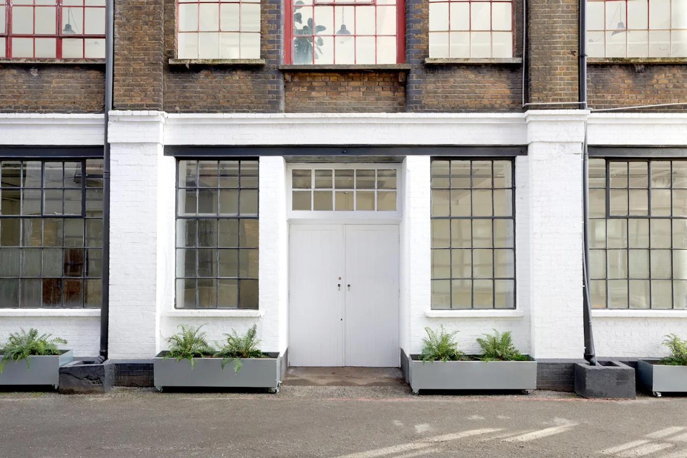 The Vale Studios entrance — white painted ground floor with black metal windows